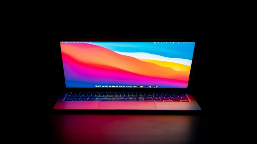 約45°の角度でディスプレイが閉じられたMacBook Pro。画面が点灯し反射している